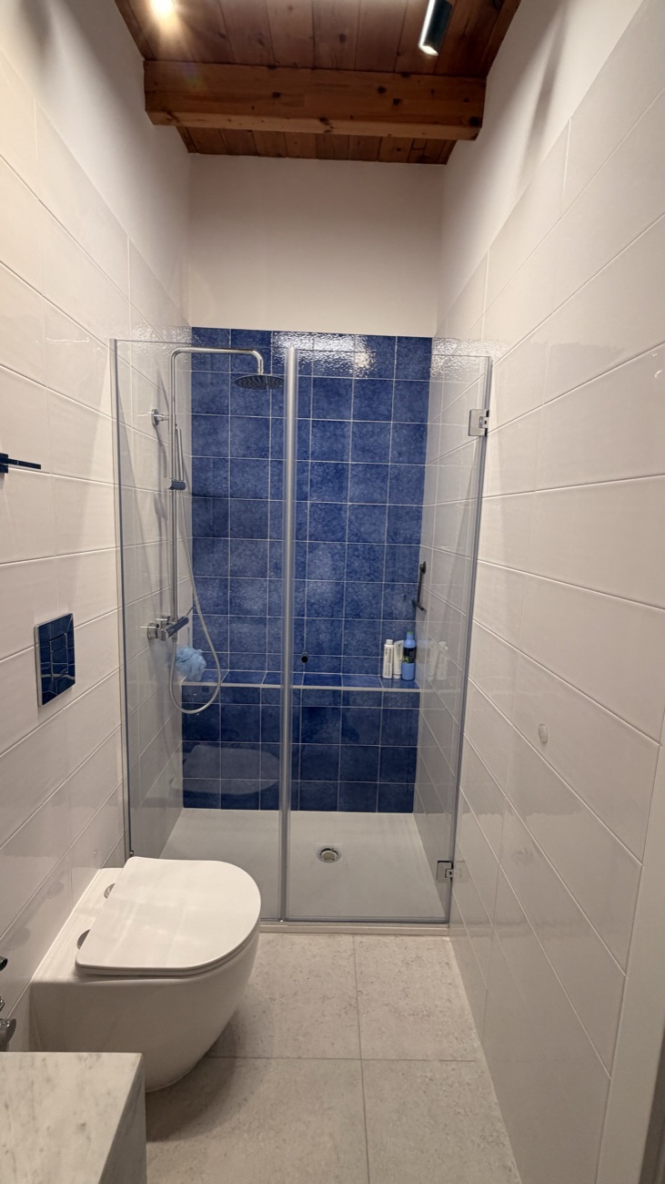Studio Secondo bathroom with a blue-tiled glass shower