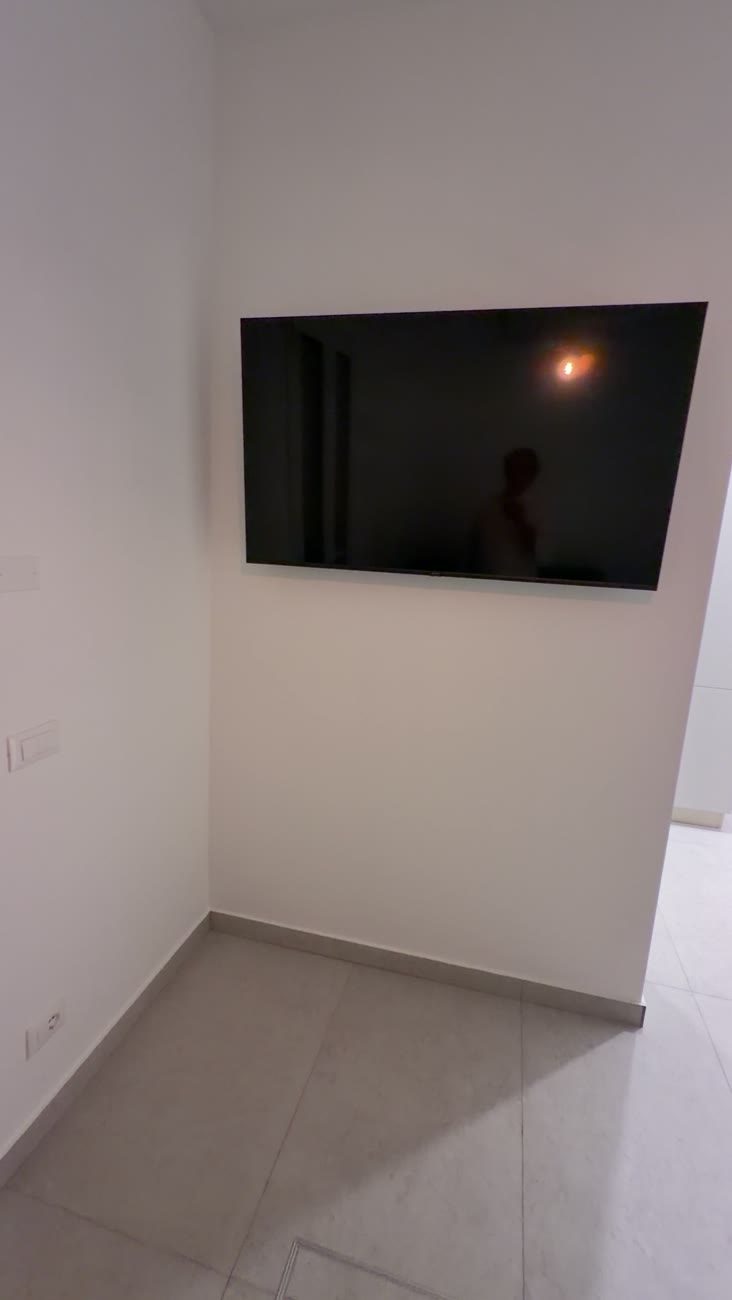 Studio Terra living area with a wall-mounted 55-inch smart TV